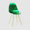 360-degree product rotation showing miniature Metallic Green MicroShell Chair from every angle - front, sides, and back - highlighting curved shell design and scale details